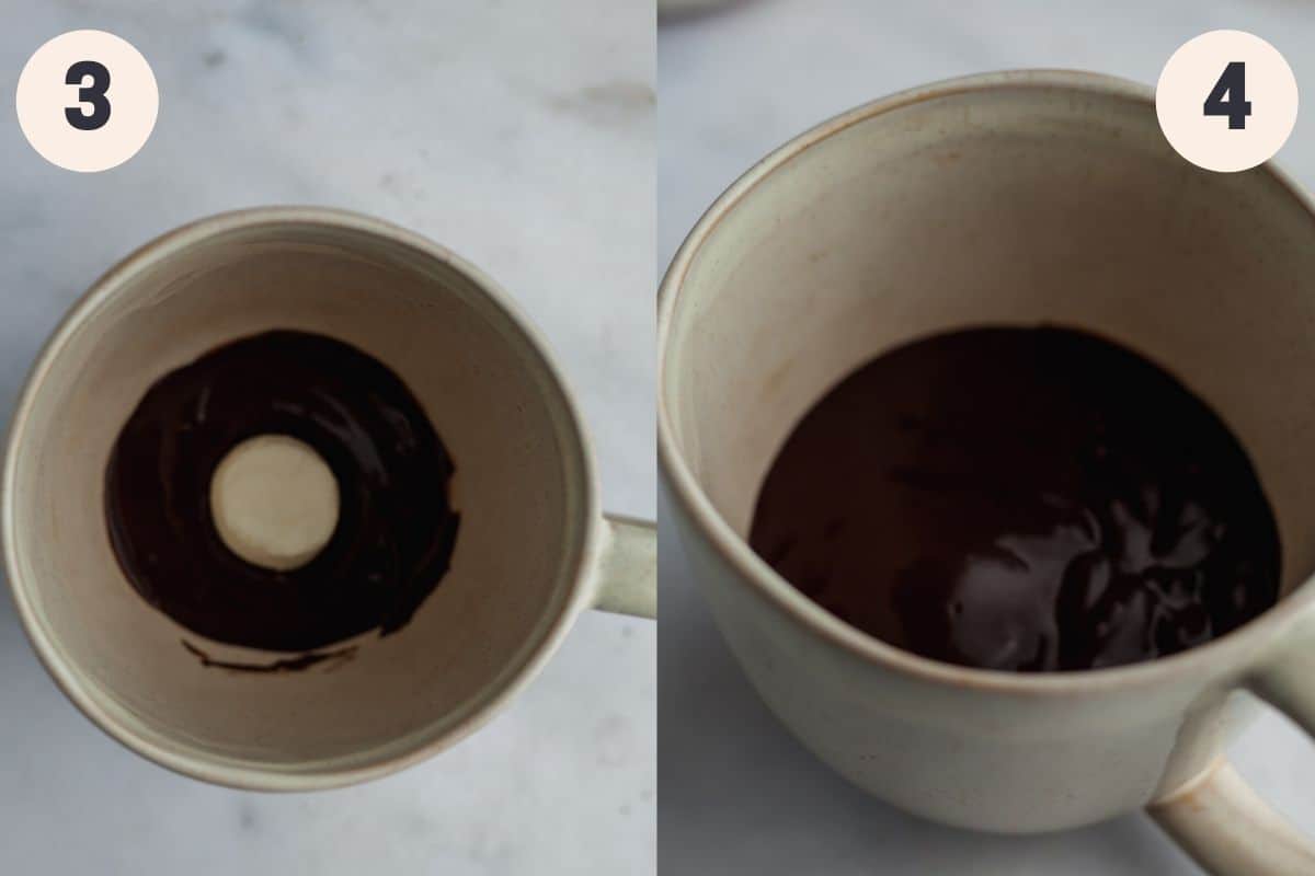 A mug with a small amount of chocolate cake batter at the bottom and a marshmallow, then it has been covered up by more batter.