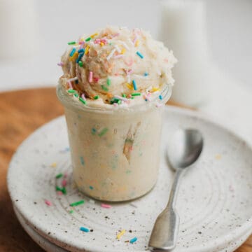 A small jam jar filled with edible sugar cookie dough and sprinkles.
