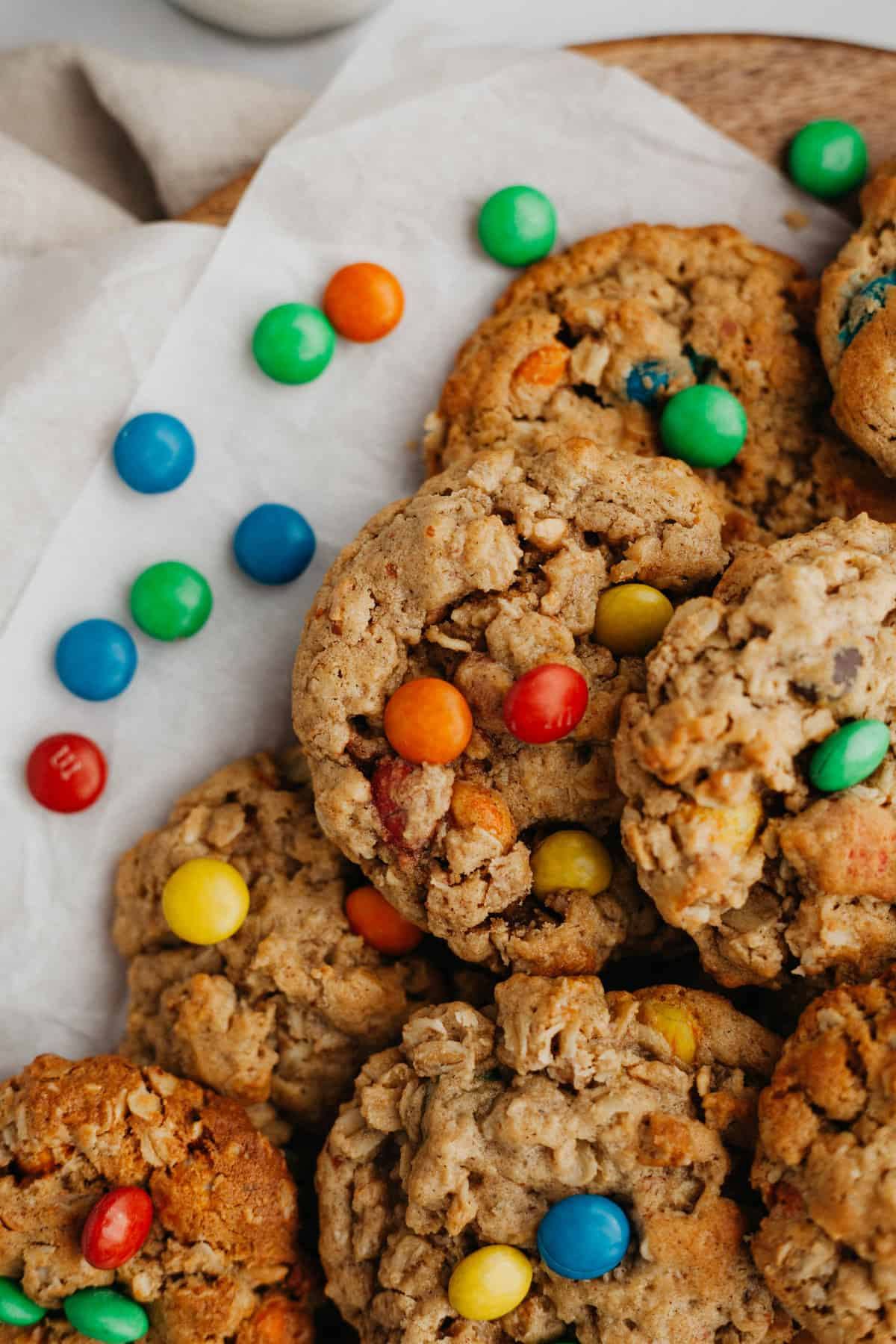 Oatmeal peanut butter M&M cookies on parchment paper.