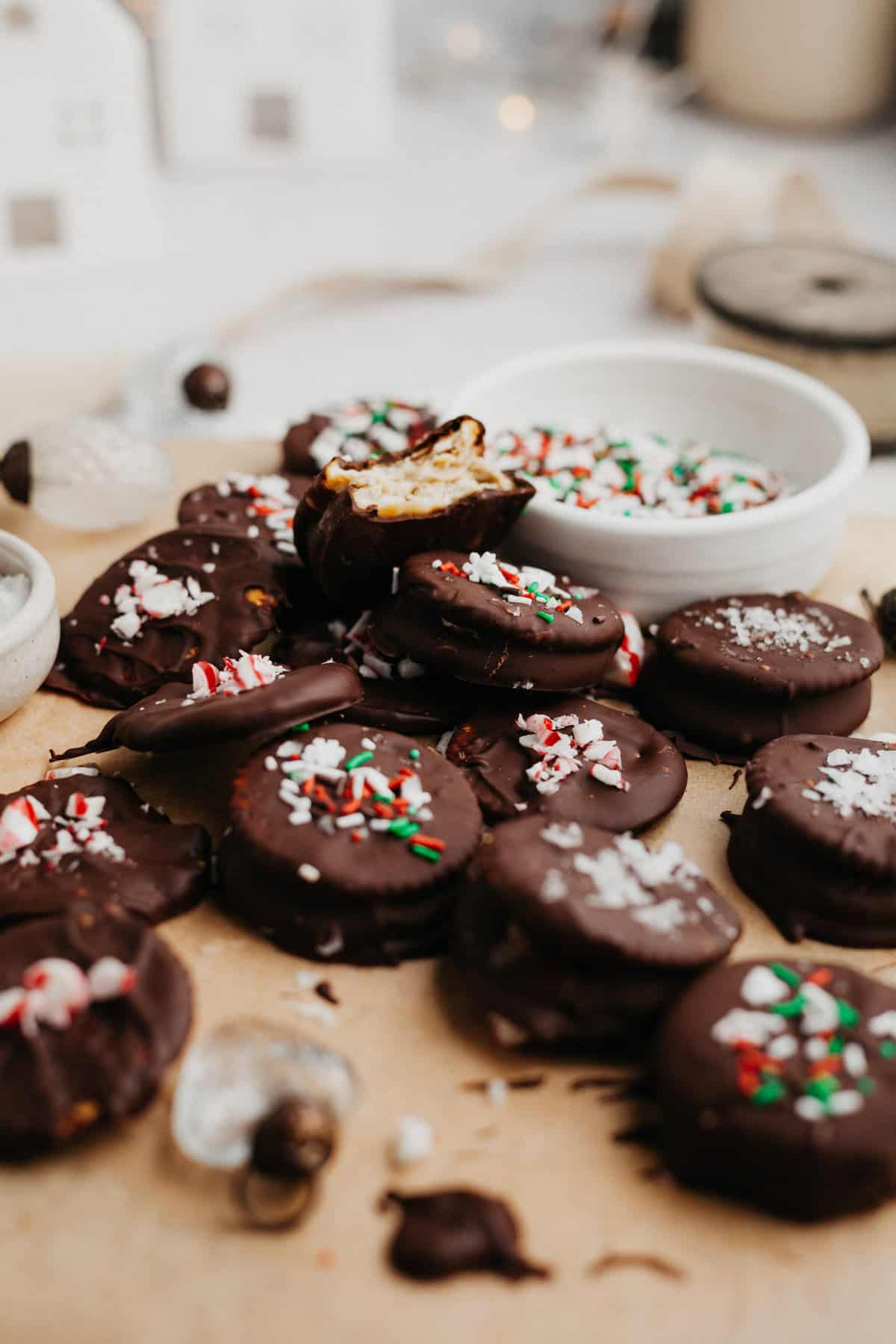 Chocolate dipped sandwich cookies covered in Christmas sprinkles.
