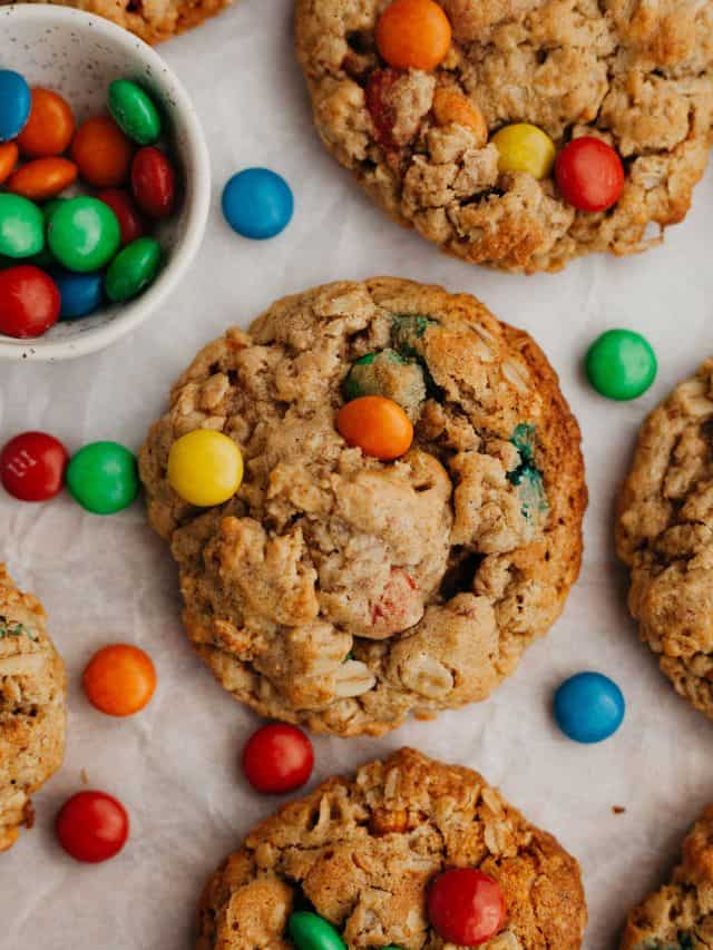 Oatmeal peanut butter M&M cookies on parchment paper.