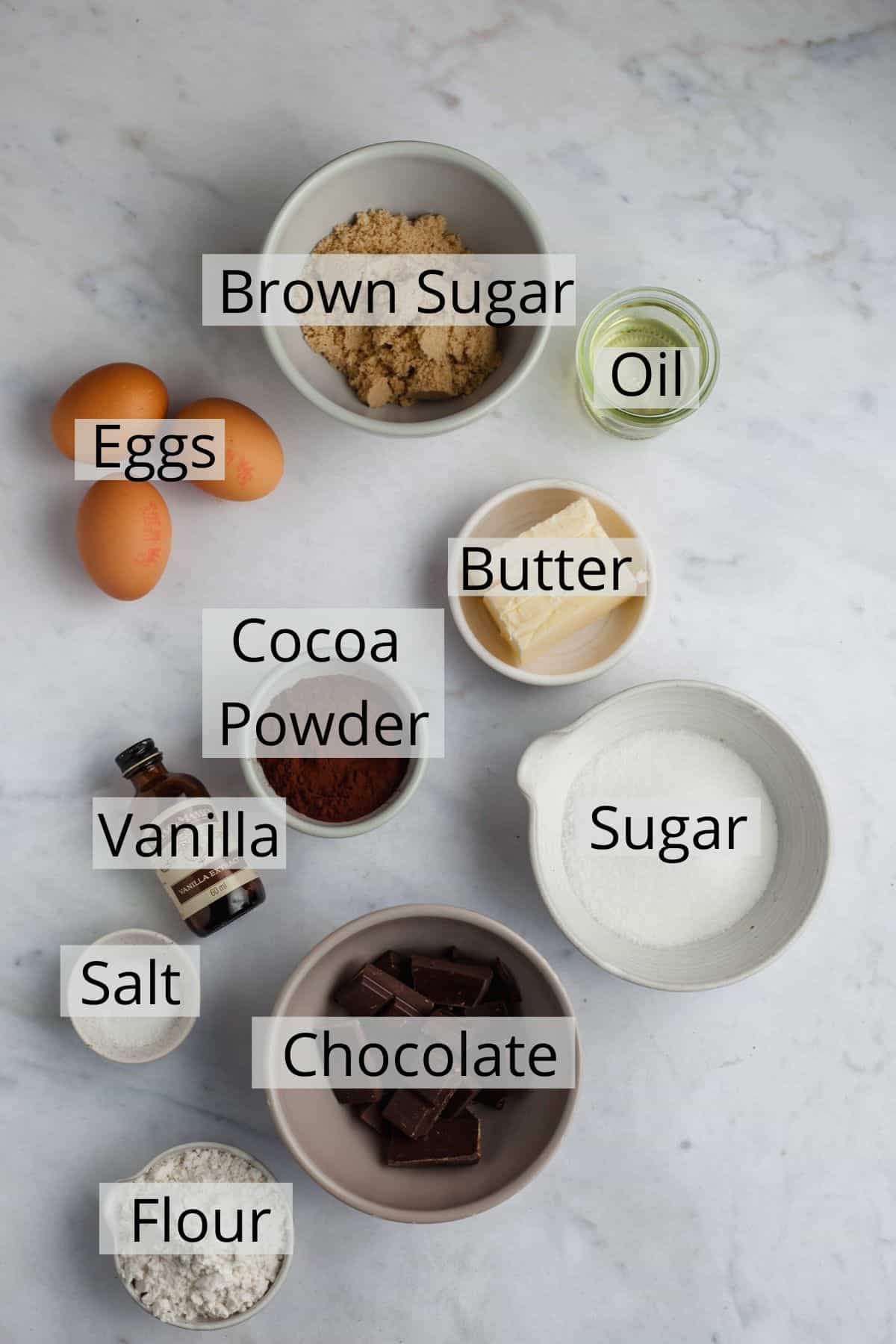 All the ingredients needed for brownies weighed out in small bowls.