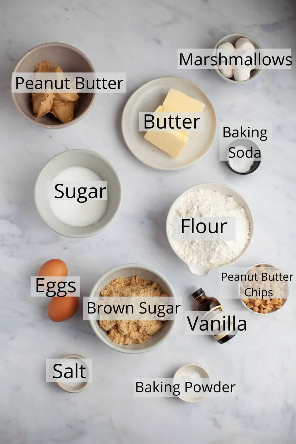 All the ingredients needed for peanut butter marshmallow cookies weighed out in small bowls.