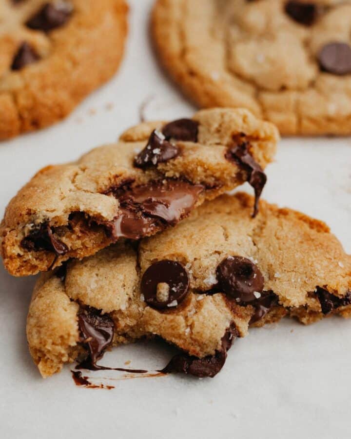 A close up of a chocolate chip cookie filled with Nutella.