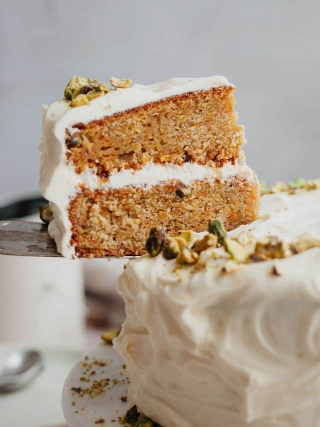 A slice of carrot cake being lifted out.