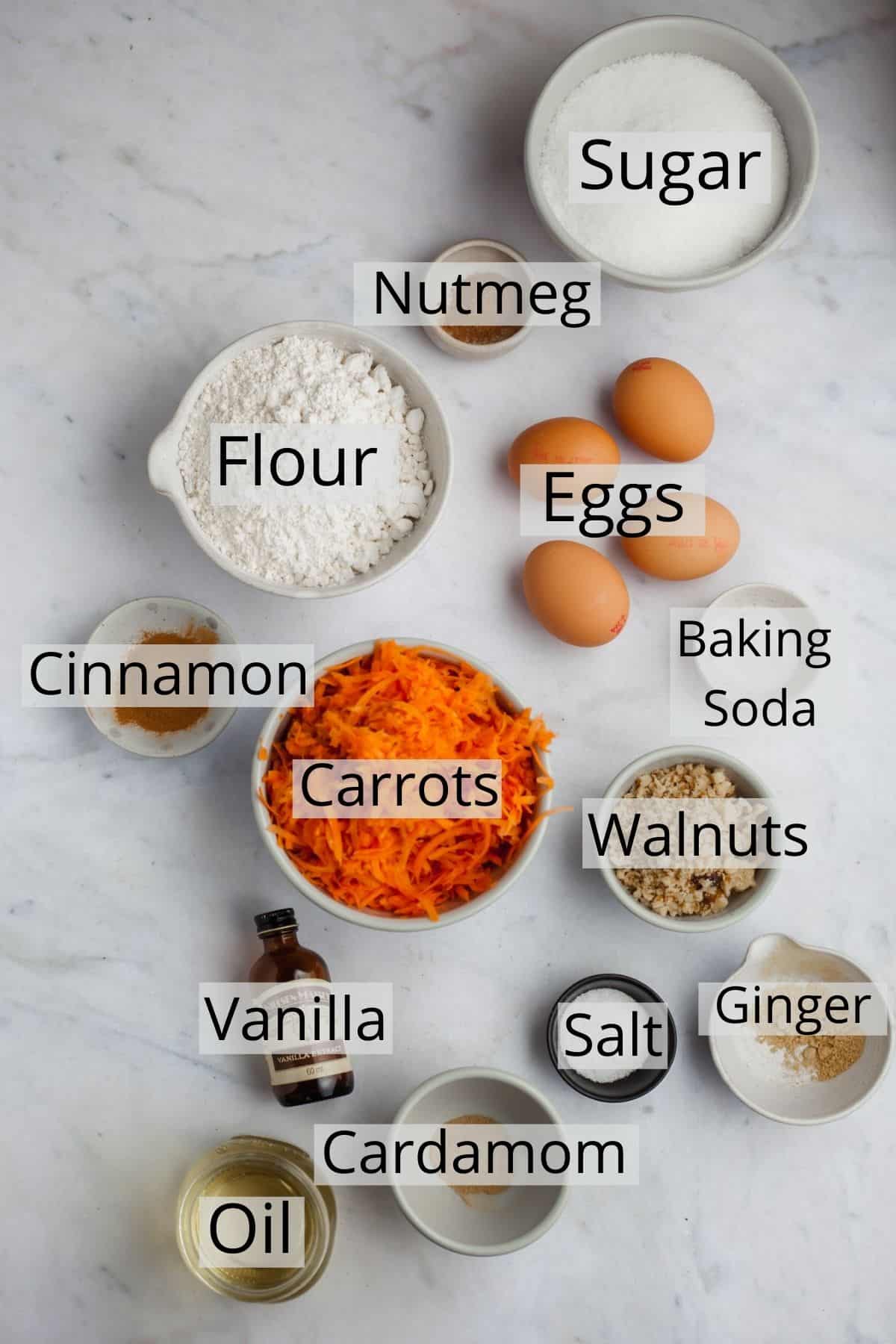 All the ingredients for carrot bundt cake weighed out in small bowls.