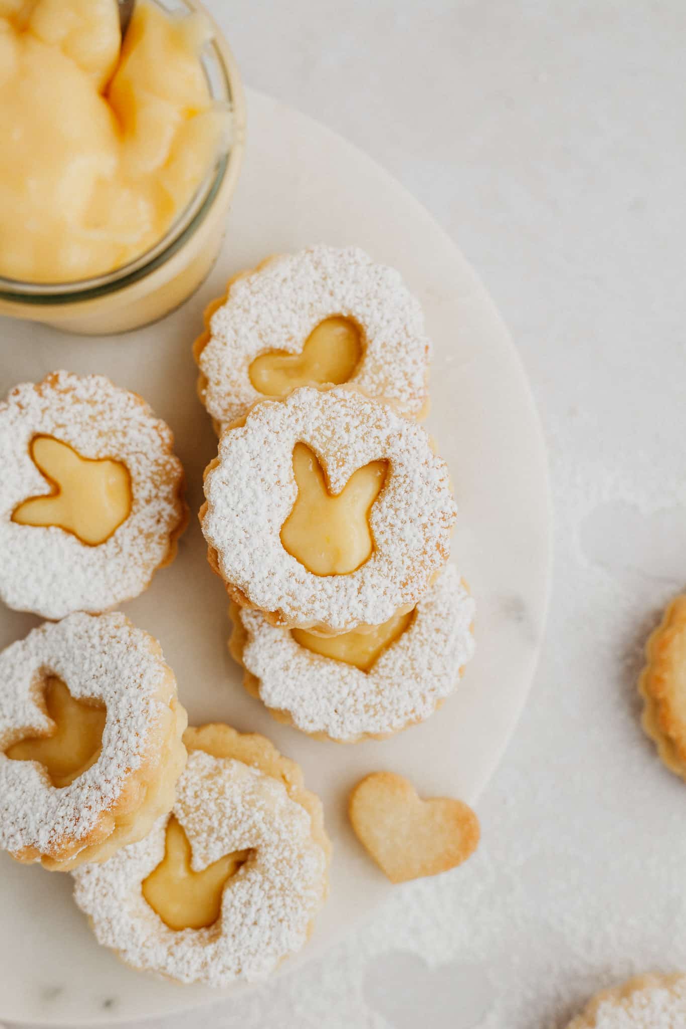 lemon curd cookies with rabbit shaped cutouts on a marble surface.