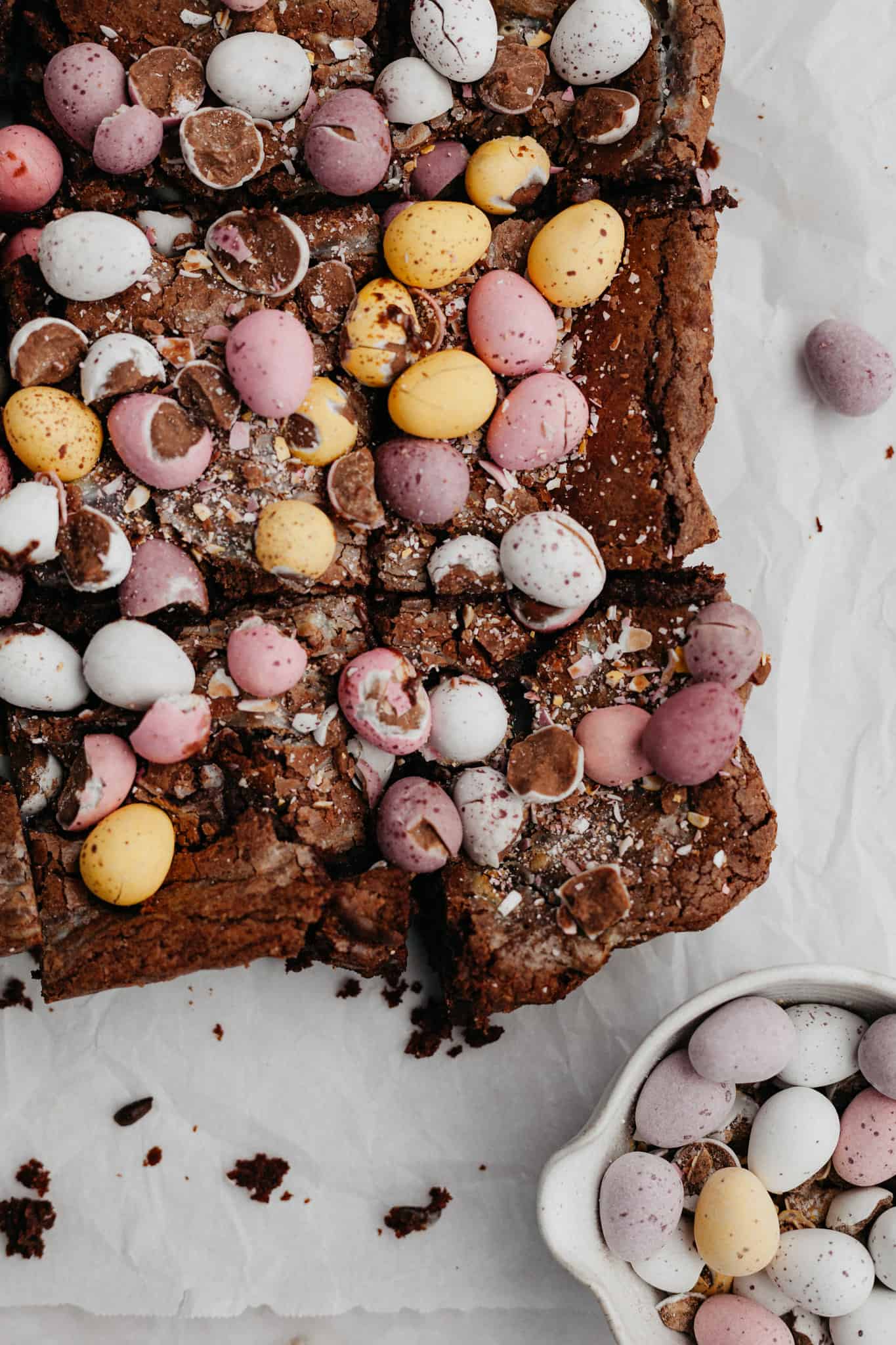 A close up of Easter brownies covered in mini eggs.