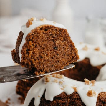 A slice of carrot bundt cake being lifted with a silver cake server.