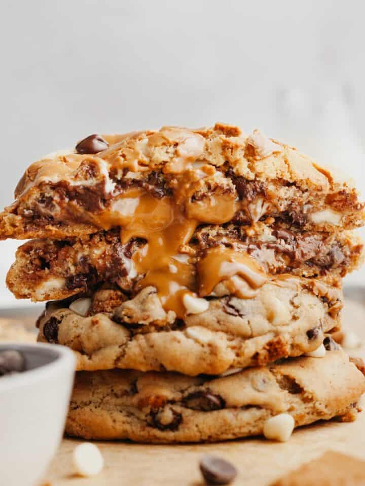 A stack of Biscoff cookies, they're cut in half with the biscoff filling coming out.