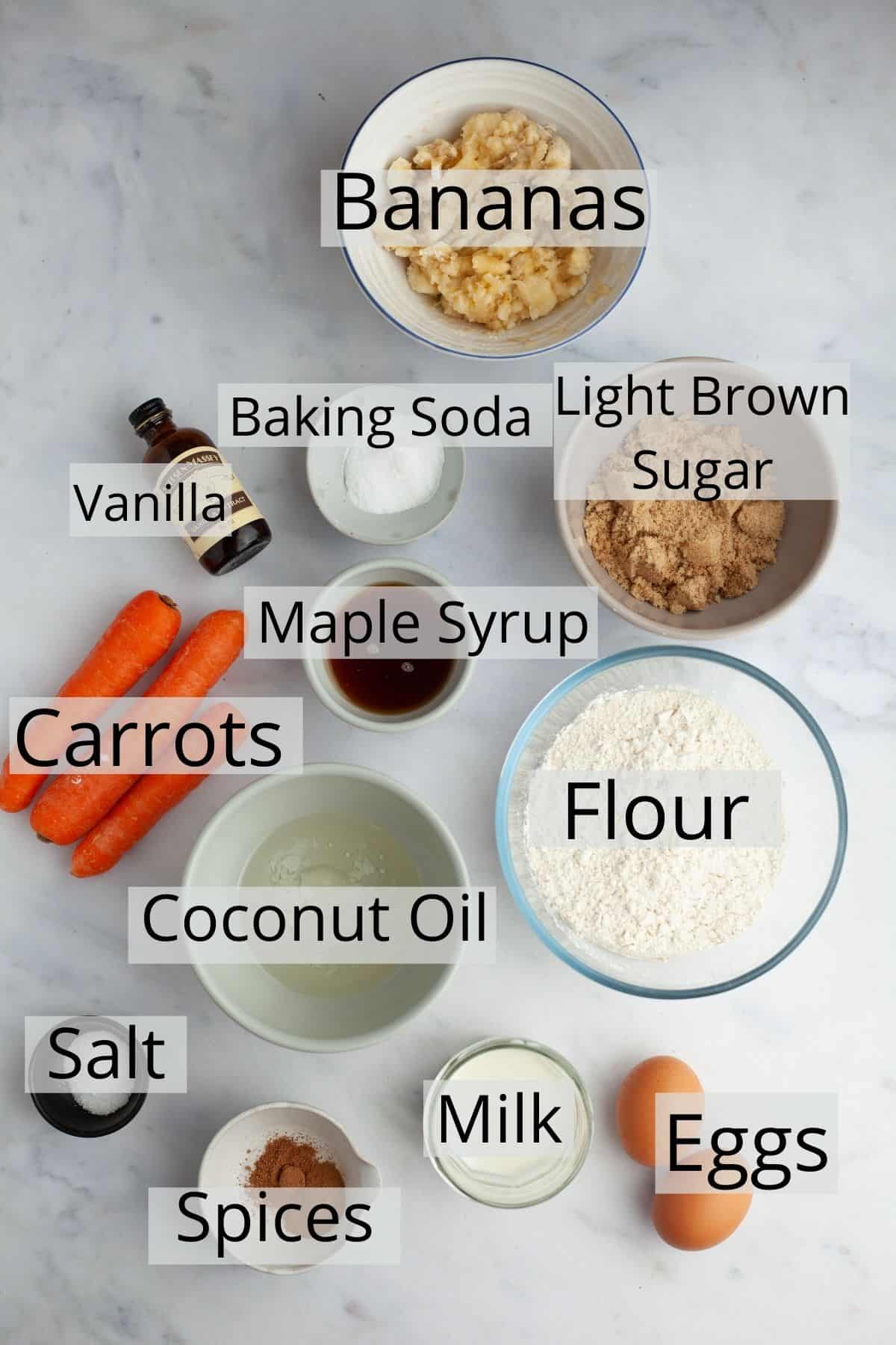 All the ingredients for banana carrot muffins weighed out into small bowls.