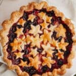 A mixed berry pie covered in star pastry cutouts.