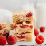 A stack of raspberry white chocolate blondies.