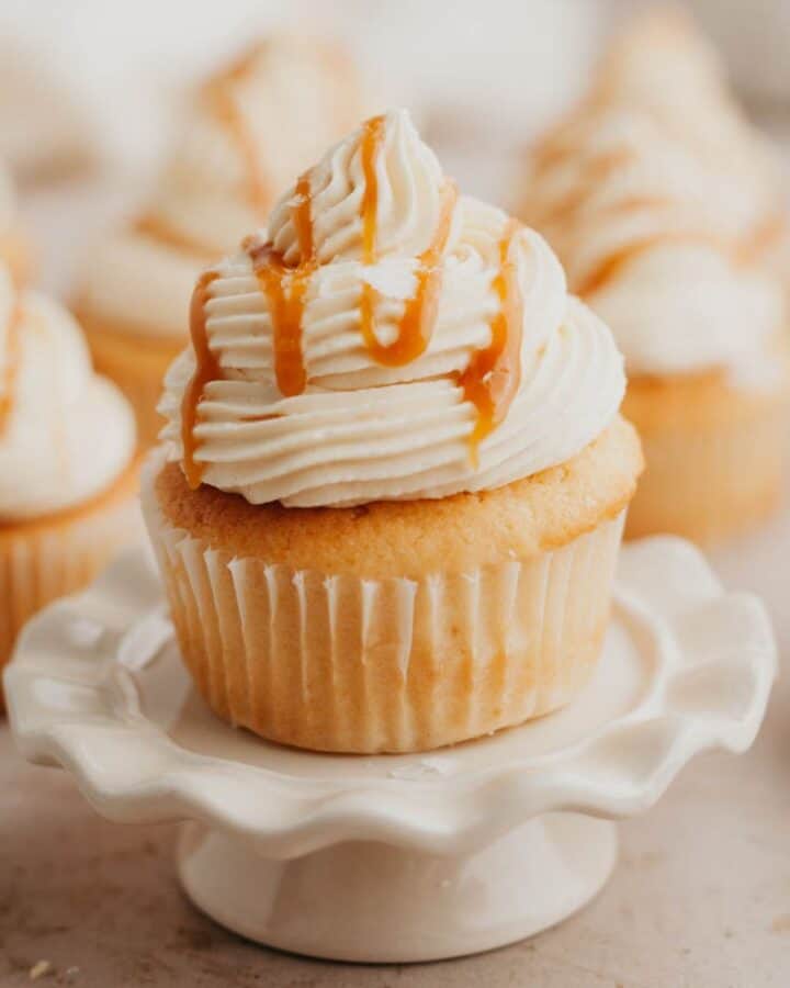 Caramel filled cupcakes, the one at the front is on a small cupcake stand.