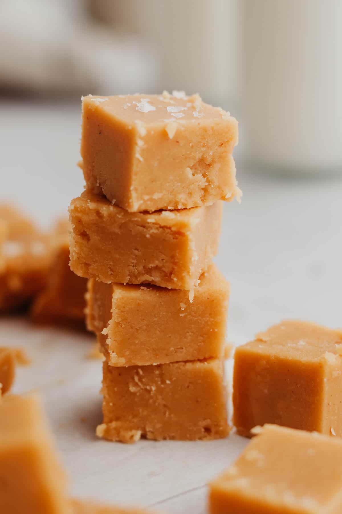 A stack of 4 pieces of no bake peanut butter fudge.