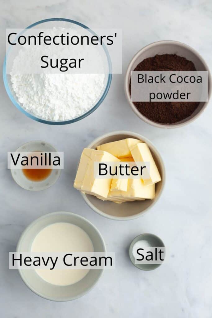 All the ingredients needed to make black velvet frosting weighed out into small bowls.