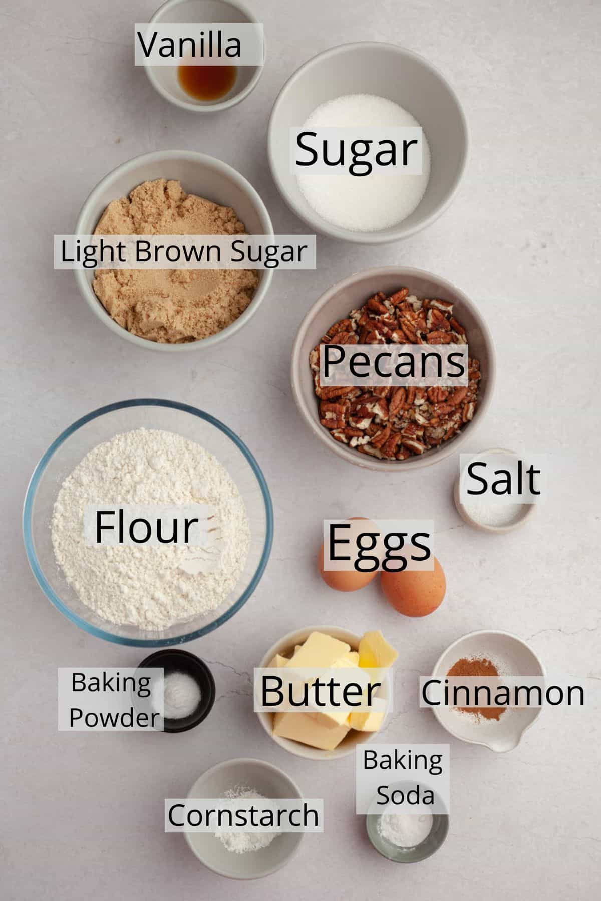 All the ingredients needed for browned butter pecan cookies weighed out into small bowls.