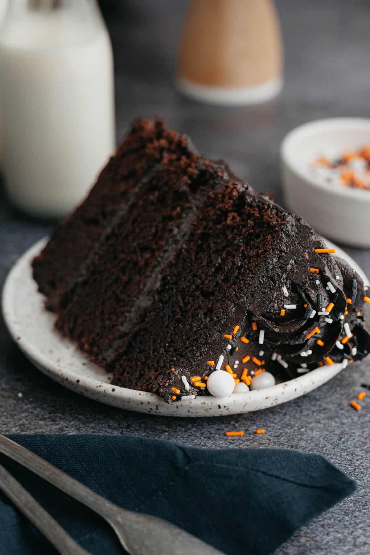 A slice of black velvet cake on a small plate.