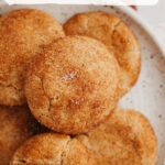 A small pile of snickerdoodle cookies on a small plate.