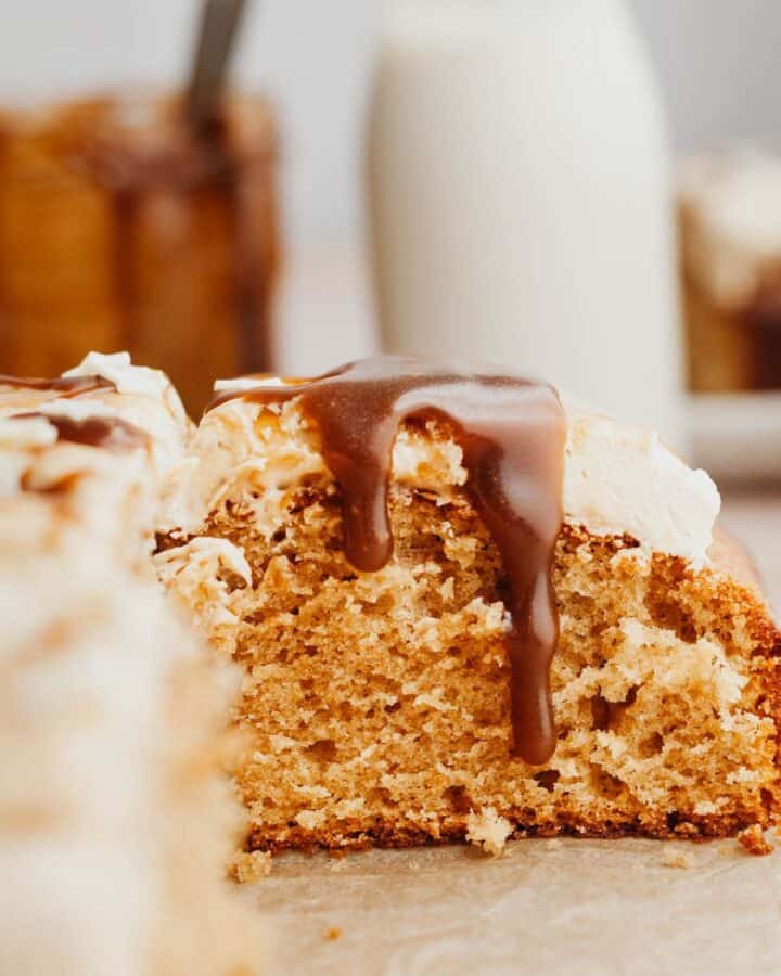 A slice of cake with butterscotch sauce dripping down.