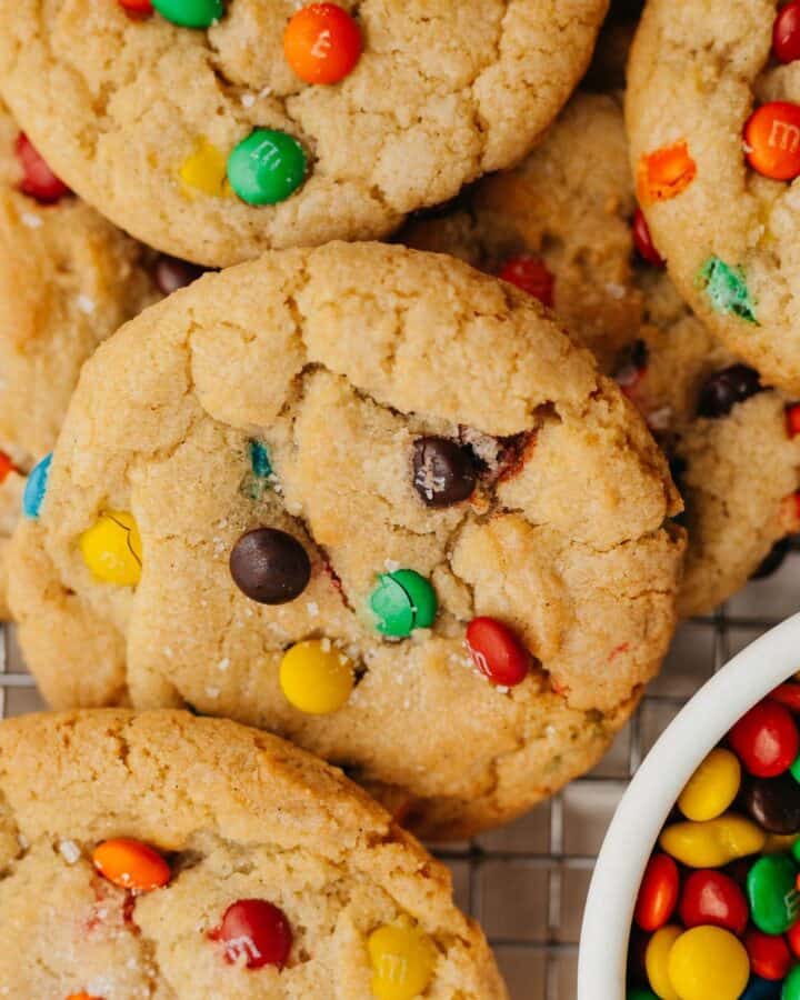 rainbow mini m&m cookies with a small bowl of mini m&ms