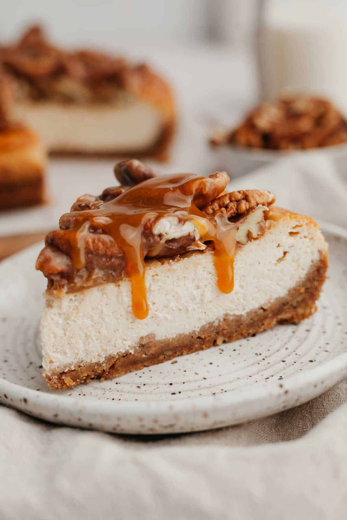 A slice of pecan cheesecake on a plate.