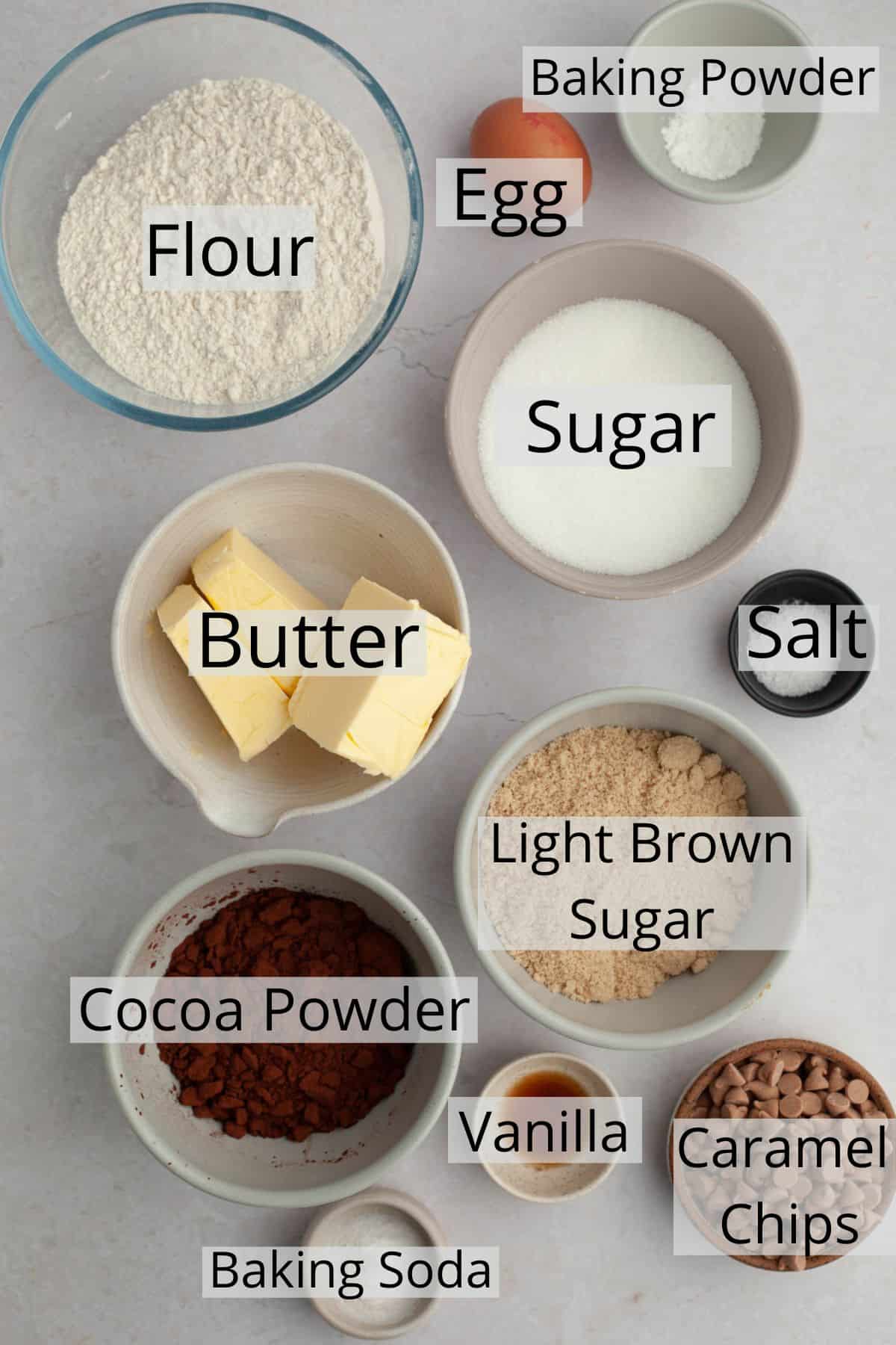 All the ingredients needed to make chocolate caramel cookies weighed out into small bowls.