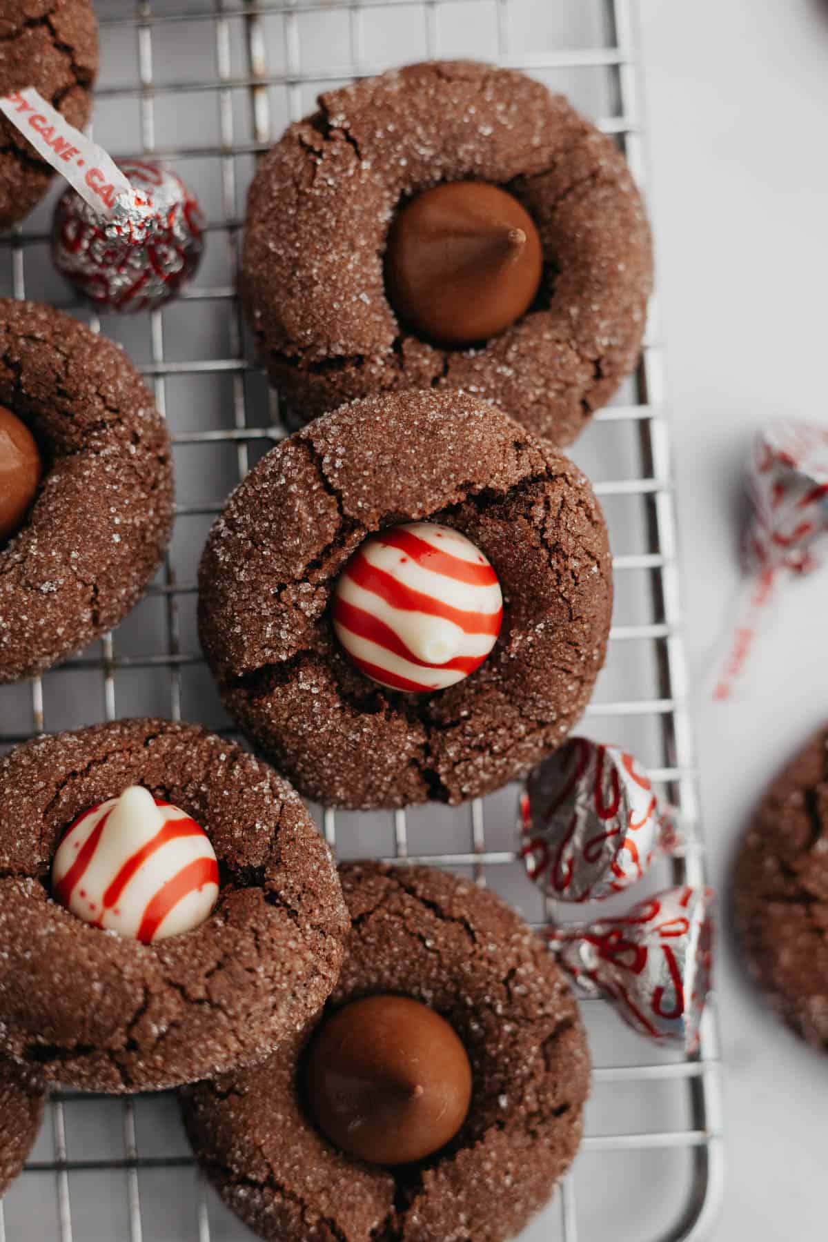 Chocolate thumbprint cookies with a chocolate kiss or candy cane kiss in the middle.