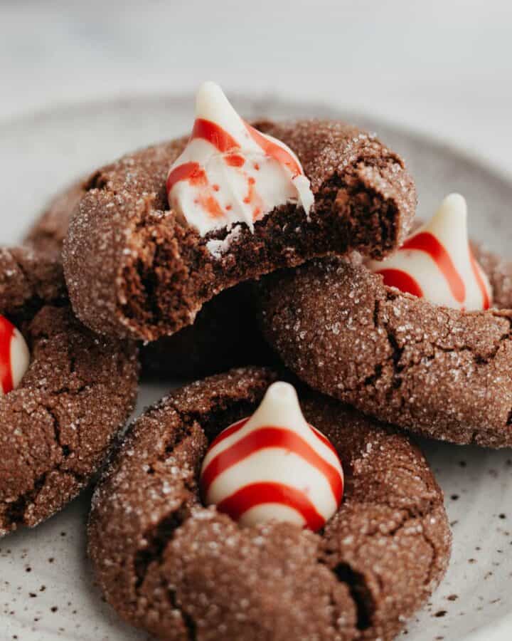 Several chocolate peppermint kiss cookies on a small plate.