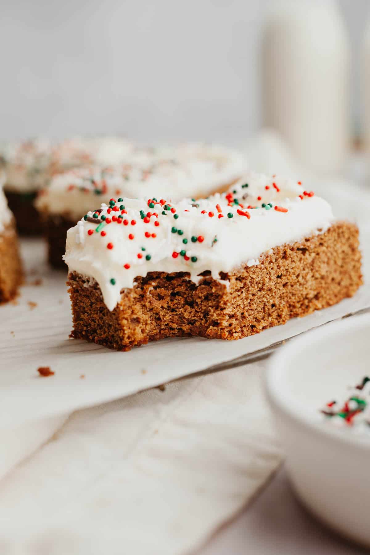 A rectangular gingerbread bar covered in cream cheese frosting.