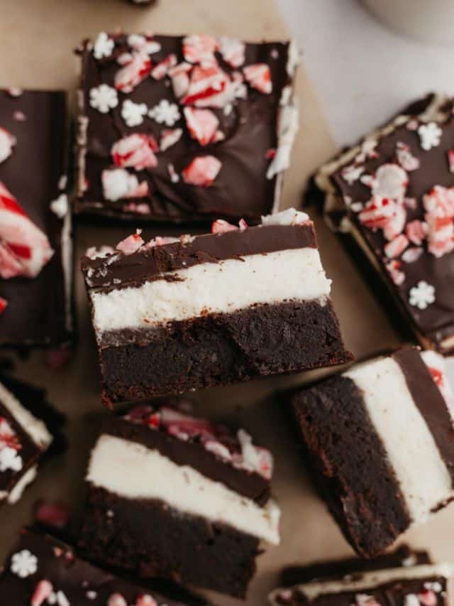 Layered peppermint brownies on parchment paper.
