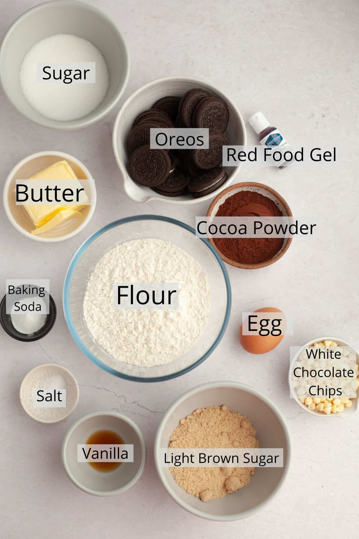 All the ingredients needed to make red velvet Oreo cookies weighed out into small bowls.