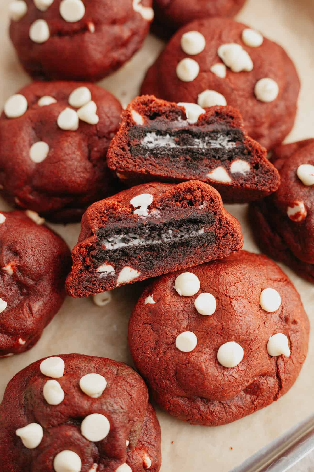 Red velvet Oreo cookies, one has been cut in half to show the stuffed Oreo.