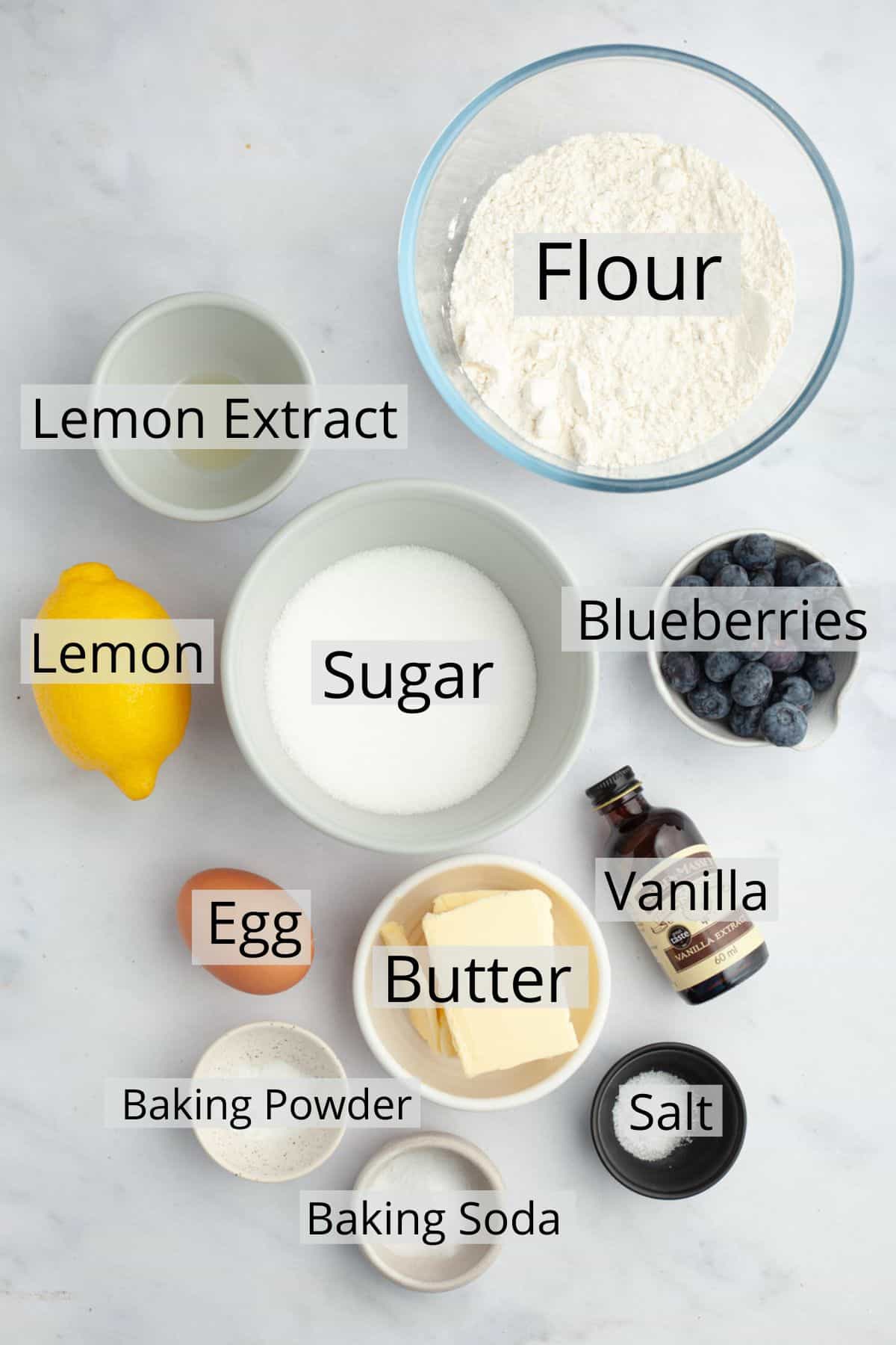 All the ingredients needed to make lemon blueberry cookies weighed out into small bowls.