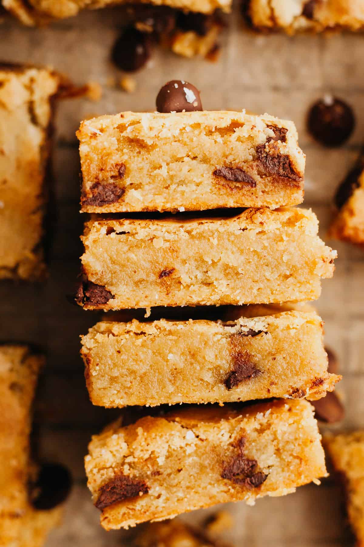 Four chocolate chip blondies on their sides stacked up.