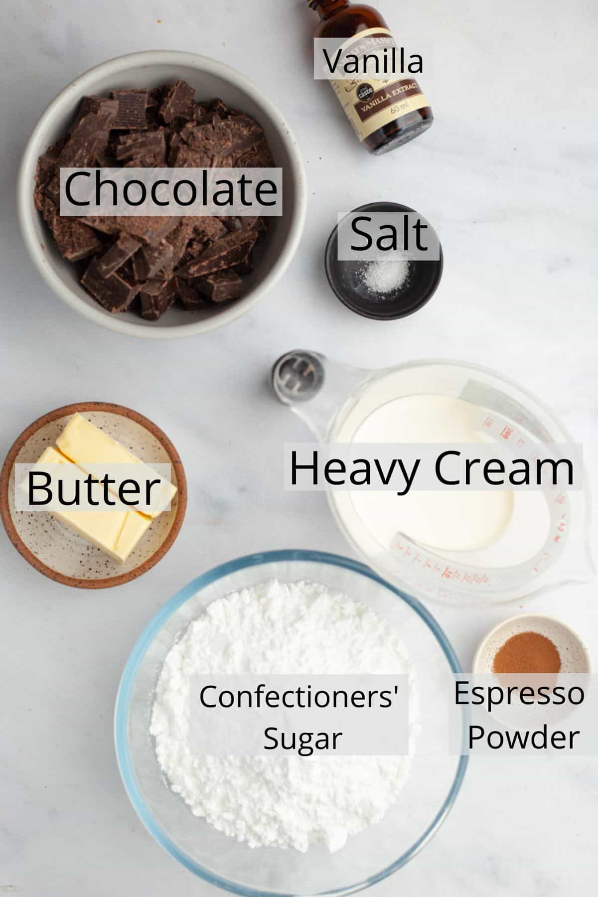 Ingredients needed to make chocolate fudge frosting weighed out into small bowls.