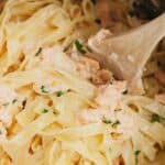 A saucepan with salmon pasta in it.