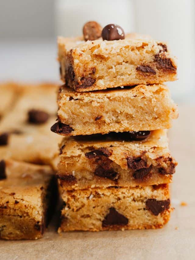 A stack of 4 chocolate chip brown butter blondies.