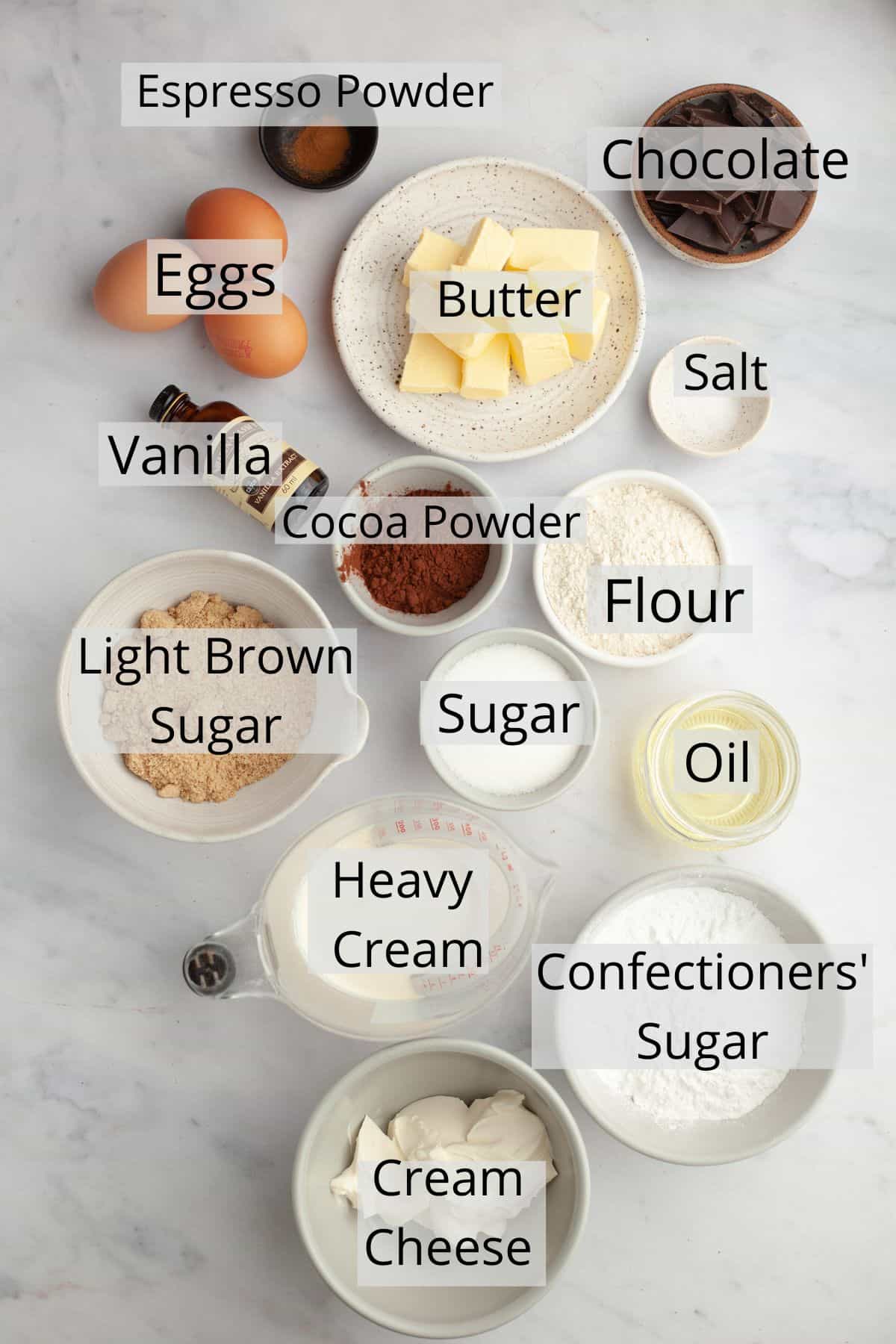 All the ingredients needed to make brownies with cream cheese frosting weighed out into small bowls.