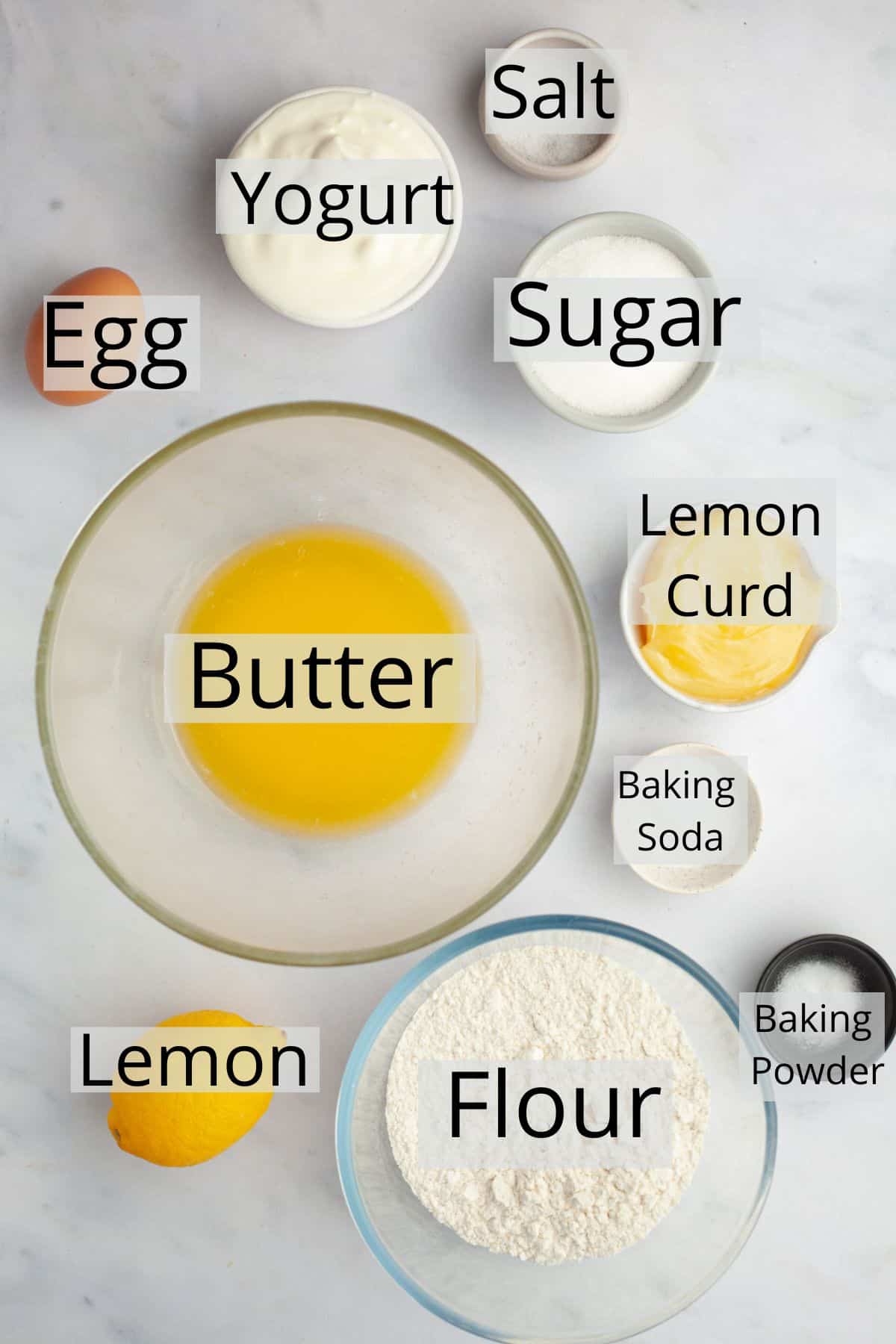 All the ingredients needed to make lemon curd muffins weighed out into small bowls.