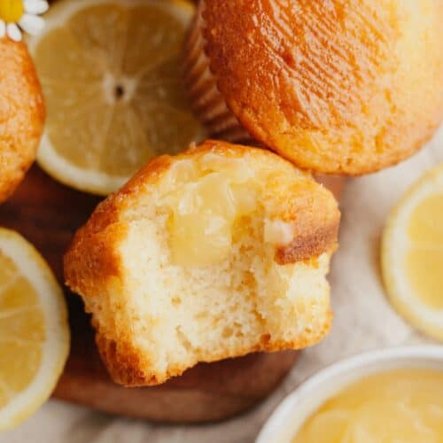 A close up of a lemon curd muffin with a bite taken out of it.