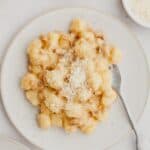 Gnocchi carbonara on a white plate.