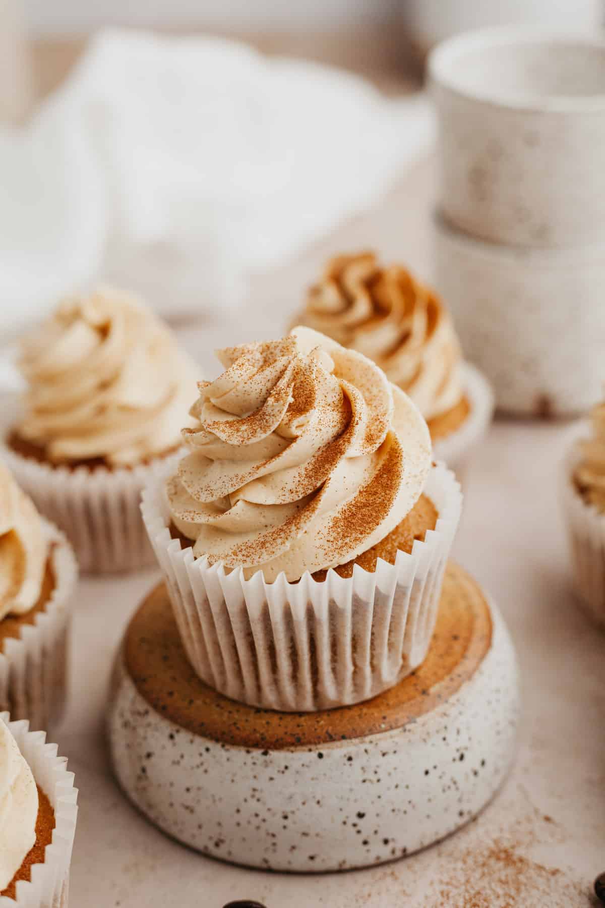 A close up of an espresso cupcake on an upturned bowl.