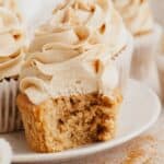 A close up of a coffee cupcake with a bite taken out of it.