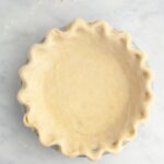 Unbaked pie dough in a pie pan.