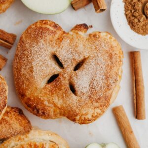 A close up of an apple shaped mini apple pie.