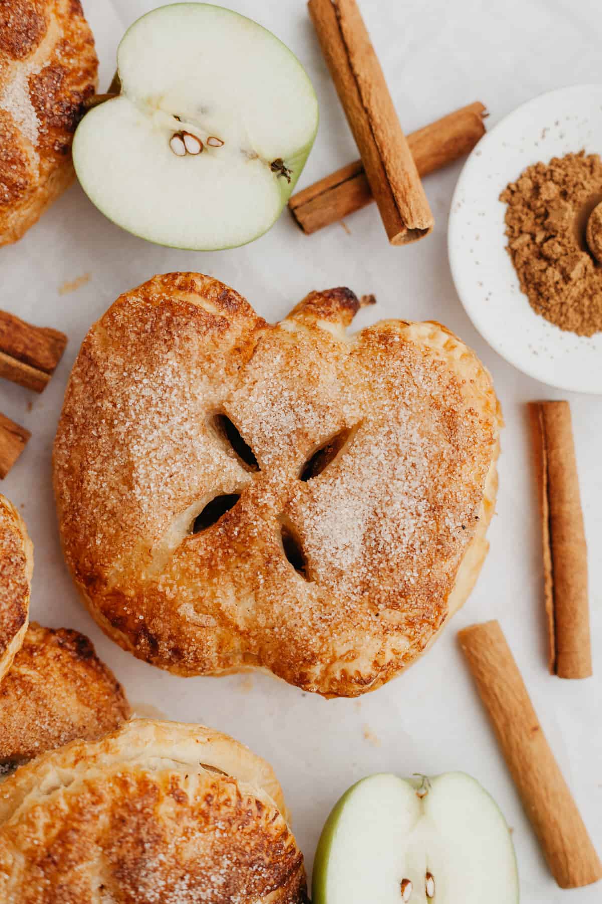 A close up of an apple shaped mini apple pie.