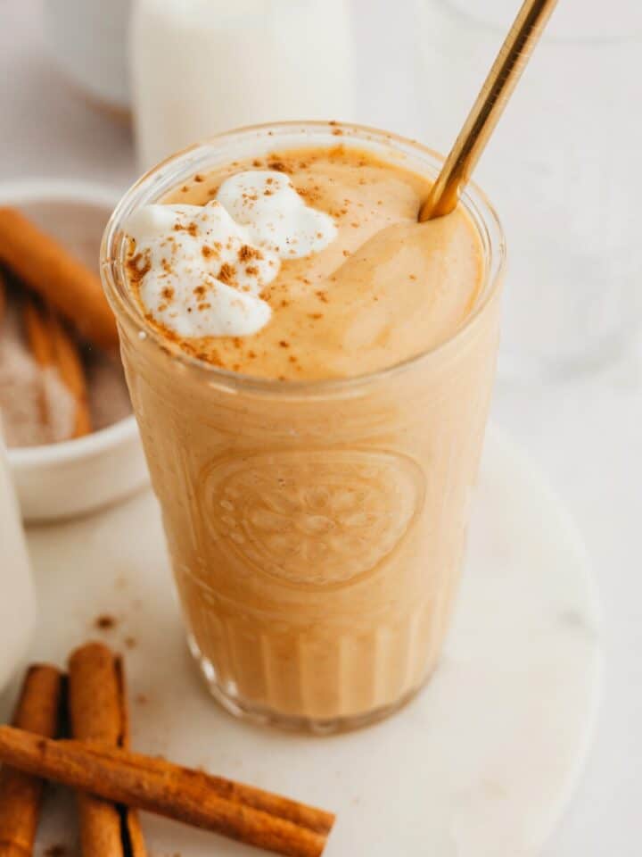 A pumpkin smoothie in a large glass.