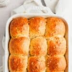 Baked garlic dinner rolls in a white baking dish.