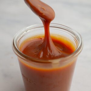 a jar of salted caramel with a spoon.